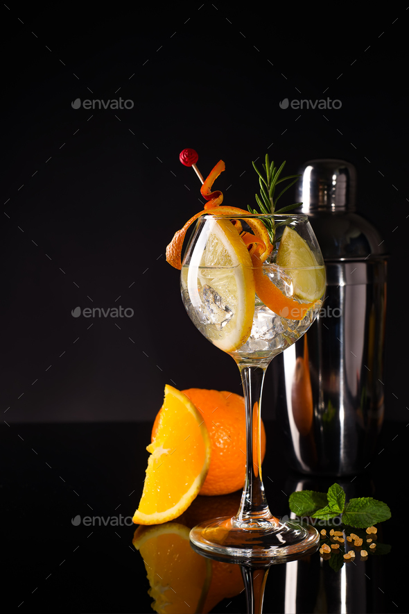 Glass of a cold cocktail drink with white wine served with brown sugar, orange and shaker - Stock Photo - Images