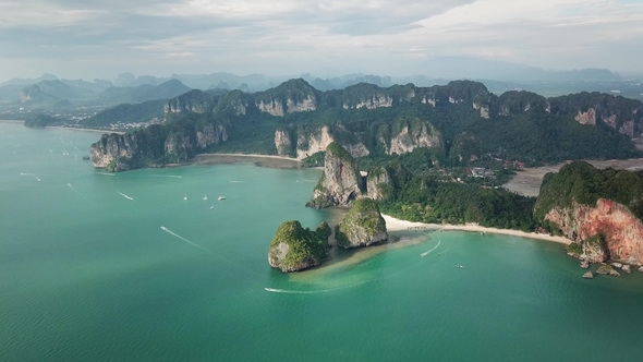 Aerial of Tropical Beach Between Rocks and Islands alt
