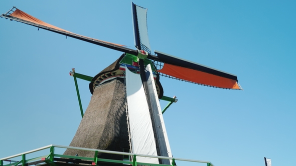 An Old Dutch Windmill. Against the Background of the Blue Sky alt