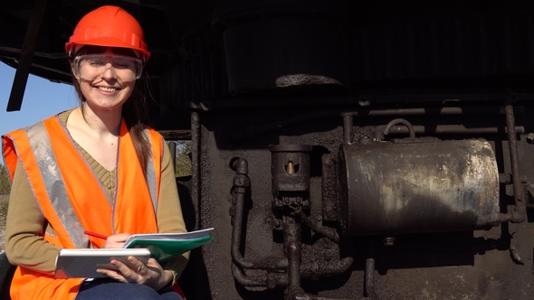A Worker Checks of the Hydraulic System of a Career Excavator. alt