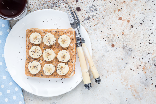 Healthy breakfast sandwich with crunchy peanut butter, banana an - Stock Photo - Images