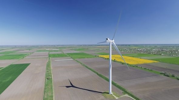 Aerial View Looking Across Wind Turbines in Motion on a Summers Day
