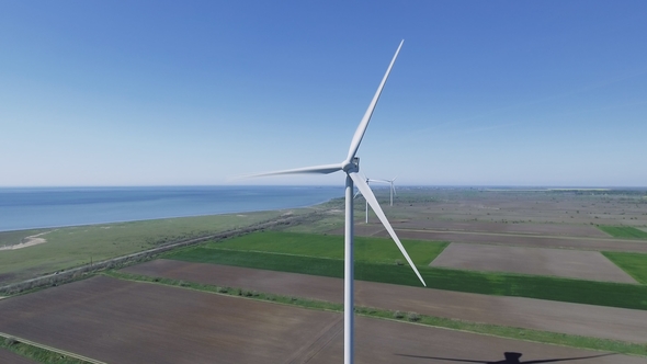 Aerial View Looking Across Wind Turbines in Motion on a Summers Day alt