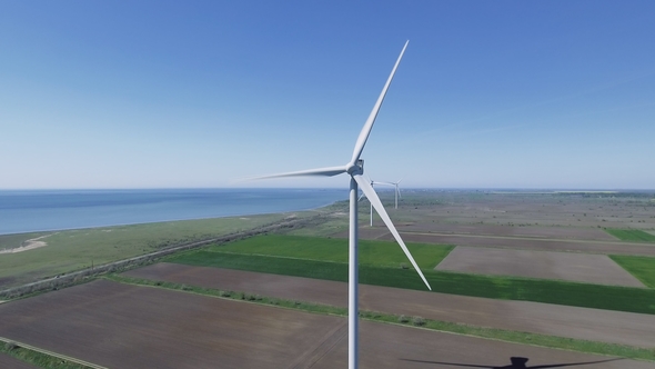 Aerial View Looking Across Wind Turbines in Motion on a Summers Day
