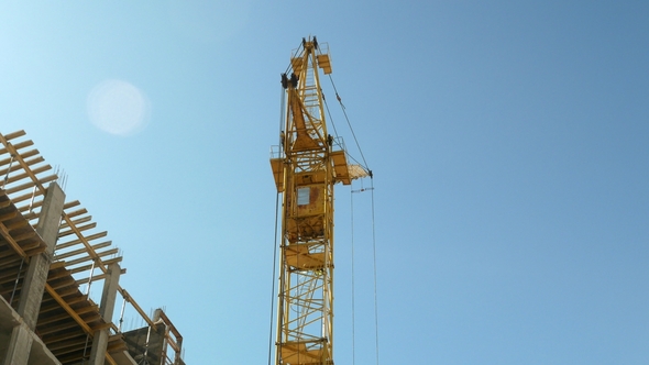 Construction Crane Working by Tower Building