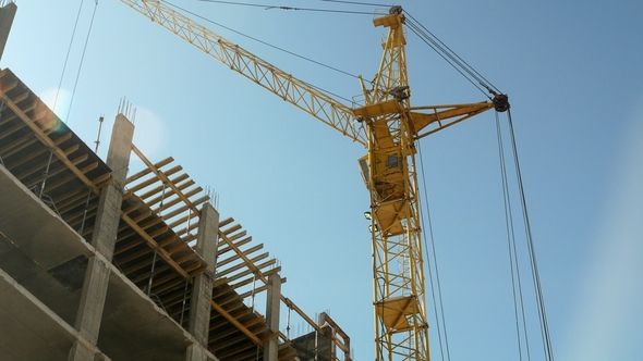 Construction Crane Working by Tower Building