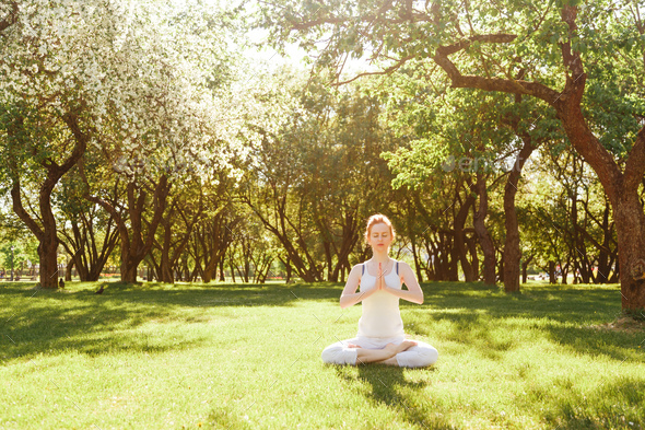 Young Red Hair Woman Peacefully Meditating In Park Stock Photo By Vladdeep