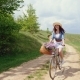 Woman in a Hat on a Bicycle Traveling in Nature - VideoHive Item for Sale