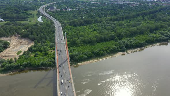 Car traffic on hanging sea bridge over bay in city view from above. Aerial View alt