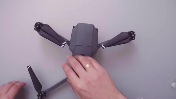 Hands of a Man Packing a Drone for a Flight