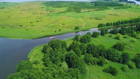 Flight Over River in Meadows