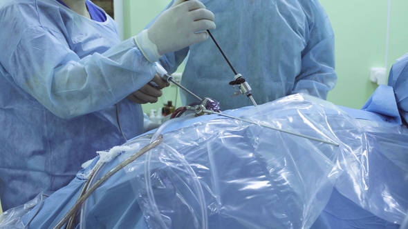 Two Doctors and Nurse During Laparoscopic Surgery