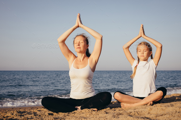 Happy family standing on the beach at the day time. - Stock Photo - Images