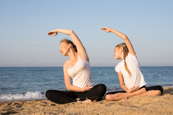 Happy family standing on the beach at the day time. - Stock Photo - Images