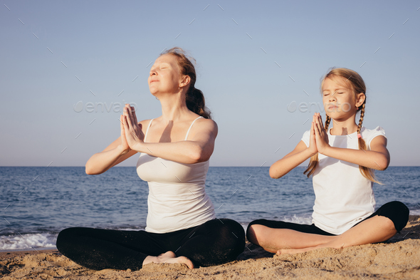 Happy family standing on the beach at the day time. - Stock Photo - Images