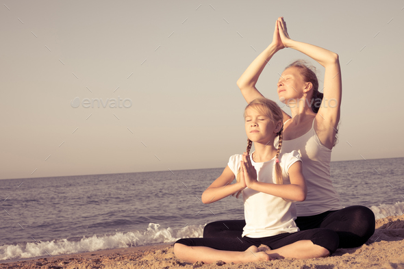Happy family standing on the beach at the day time. - Stock Photo - Images