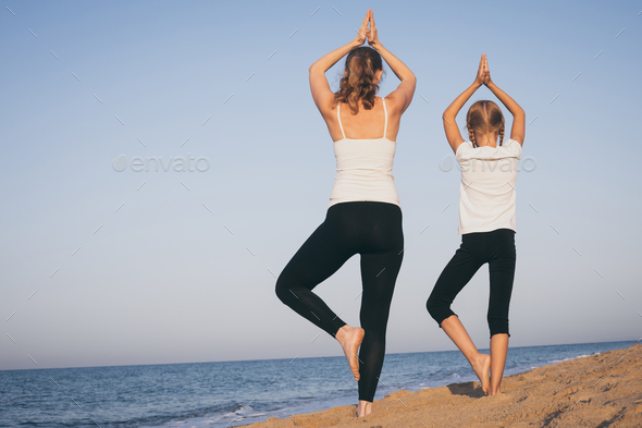 Happy family standing on the beach at the day time. - Stock Photo - Images