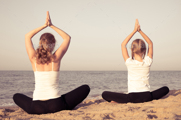 Happy family standing on the beach at the day time. - Stock Photo - Images
