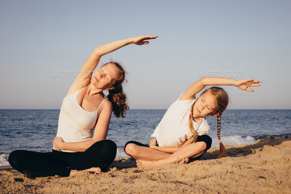 Happy family standing on the beach at the day time. - Stock Photo - Images