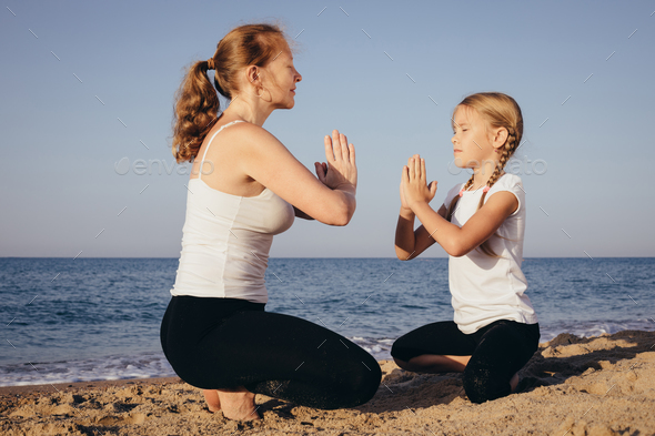 Happy family standing on the beach at the day time. - Stock Photo - Images