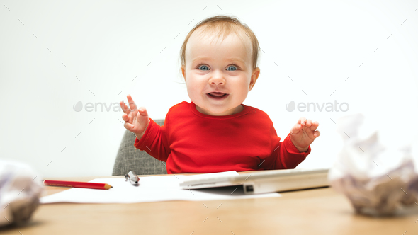 Happy child baby girl toddler sitting with keyboard of computer isolated on a white background - Stock Photo - Images