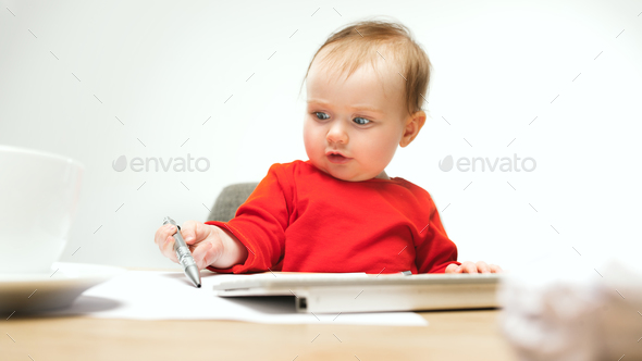 Happy child baby girl toddler sitting with keyboard of computer isolated on a white background - Stock Photo - Images