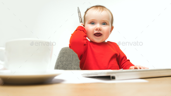 Happy child baby girl toddler sitting with keyboard of computer isolated on a white background - Stock Photo - Images