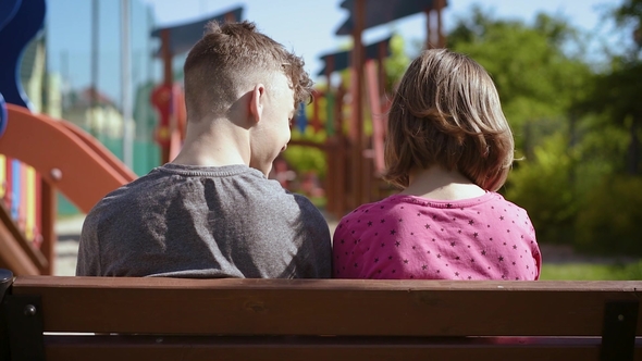 Boy and Girl Sitting on the Bench