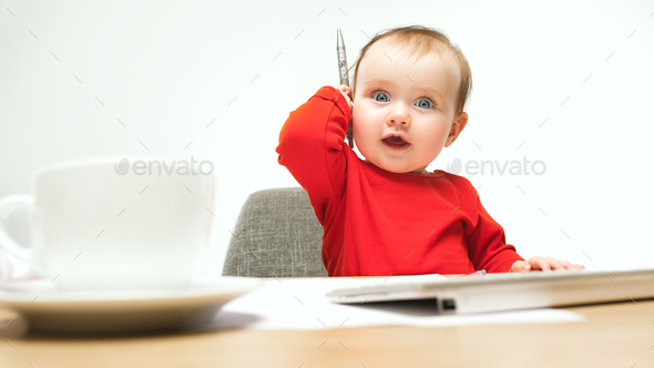 Happy child baby girl toddler sitting with keyboard of computer isolated on a white background - Stock Photo - Images