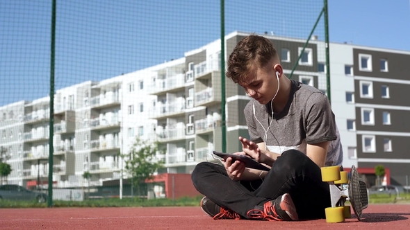 Teen Boy with Headphones and Tablet