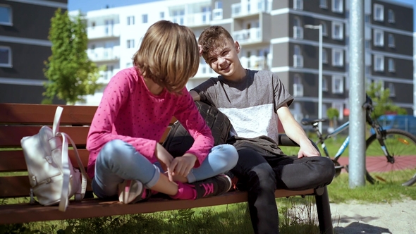 Boy and Girl Sitting on the Bench