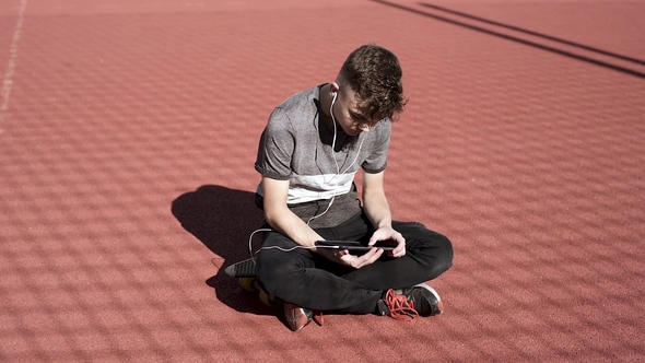 Teen Boy with Headphones and Tablet