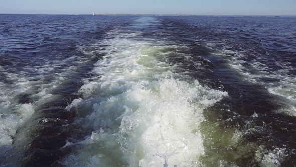 Powerful Waves Pulled Out From Fast Moving Boat, a Huge Stream of Deep Blue Water with White Foam