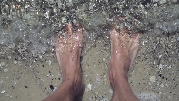 Male Feet on the Beach at Seaside, Man Standing on the Seashore with Water Covering alt
