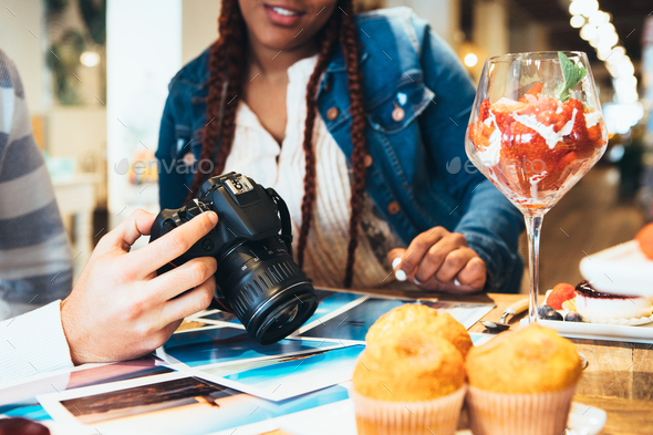 Hands of a photographer holding photo camera - Stock Photo - Images
