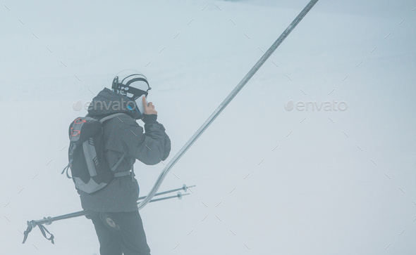 Speaking on the phone at ski lift - Stock Photo - Images