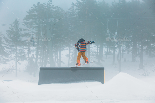 Skier doing snowboarding jumping a ramp - Stock Photo - Images