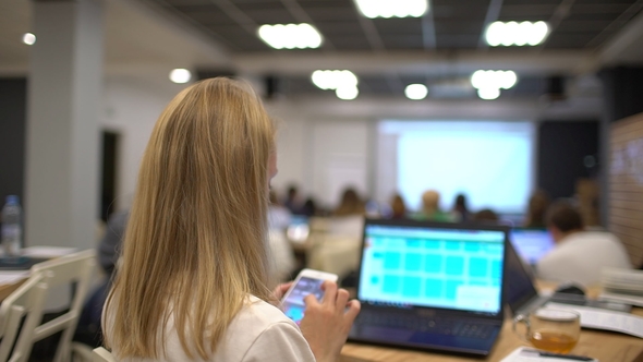Beautiful Young Student Uses Laptop While Listening To a Lecture at the University. Female Student