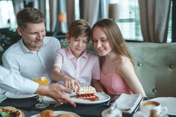 Young family in a restaurant Stock Photo by AboutImages | PhotoDune