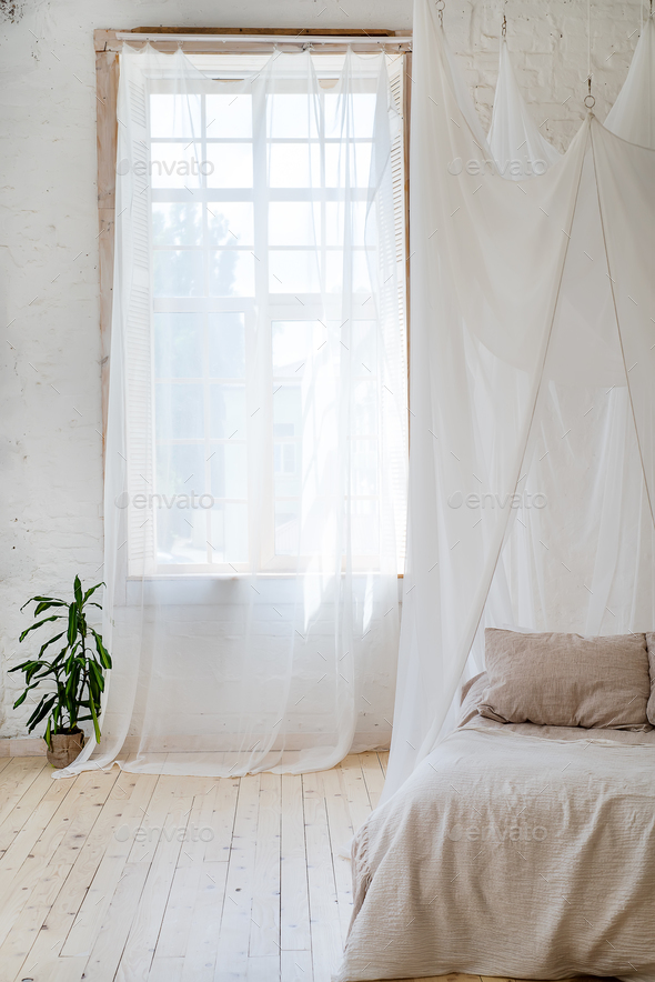 Bedroom in soft light colors with a wooden floor. - Stock Photo - Images