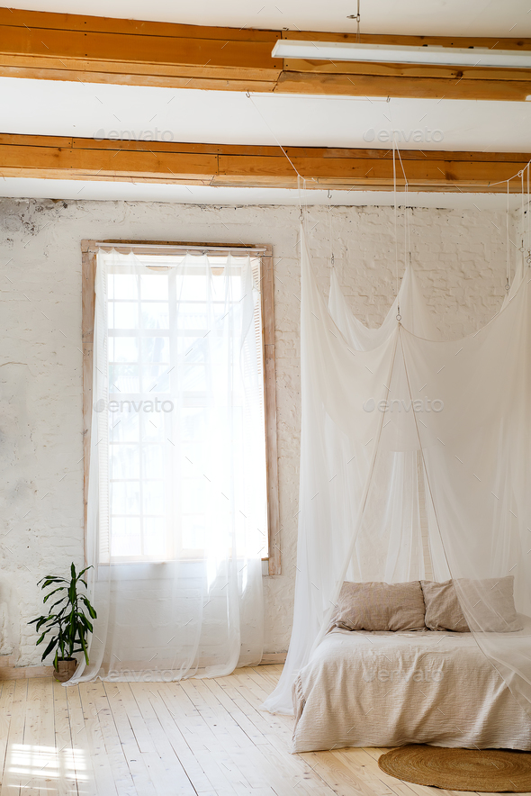 Bedroom in soft light colors with a wooden floor. - Stock Photo - Images