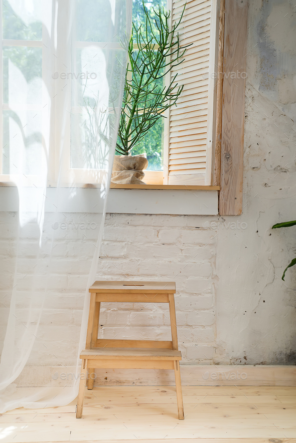 Glass windows with white curtains, flower in a pot on the floor and view over the trees. - Stock Photo - Images