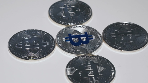 Shot of Silver Bitcoins Rotating on Background alt
