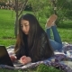 Asian Girl Working with Her Notebook Lying on Lawn - VideoHive Item for Sale