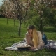 Charming Young Woman Reading a Book in Spring Park - VideoHive Item for Sale