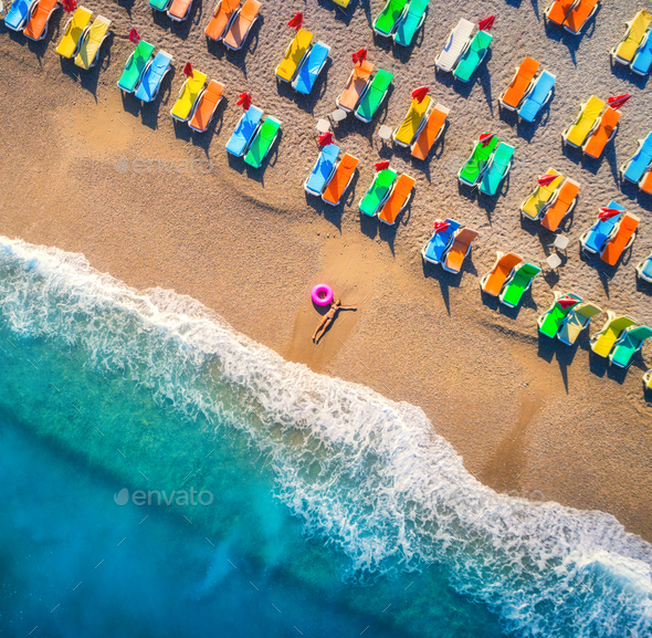 Aerial view of lying woman with swim ring in the sea - Stock Photo - Images