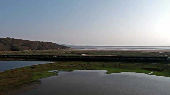Aerial View of the Glaslyn Marshes Close To the Railway with the Snowdonia Mountain Range National alt