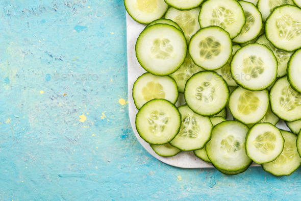 Cucumber slices, food border background on white marble Stock Photo by merc67