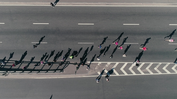 Aerial Drone Fooage. Marathon Running on Street. Group of Support. Top View