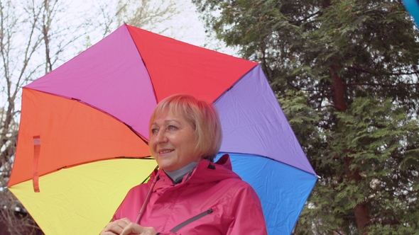 Old Woman with Umbrella in Park alt